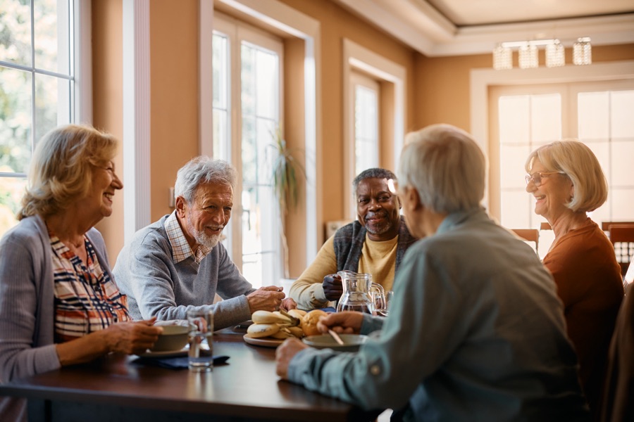 Group of seniors enjoying conversation over lunch